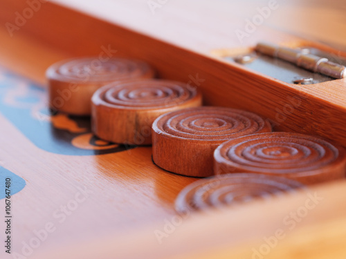 Wooden game pieces arranged neatly on a traditional backgammon game board.