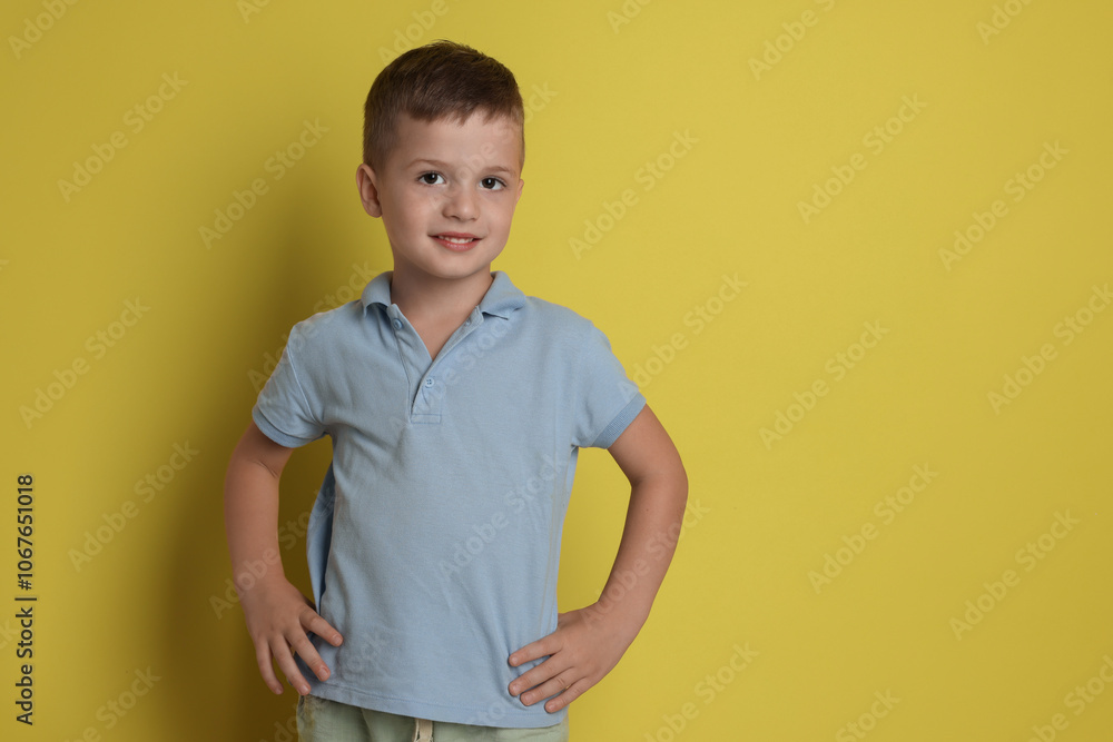 Portrait of cute little boy on yellow background, space for text Portrait of cute little boy on yellow background, space for text