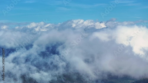 Exploring serene cloud formations over breathtaking mountain landscapes during a clear sunny day in the afternoon sky. Corsica photo