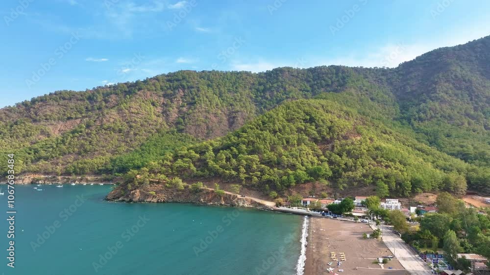 Camera slowly pans to the right, revealing a beautiful mediterranean coastline with turquoise waters and lush green trees Camera slowly pans to the right, revealing a beautiful mediterranean coastline with turquoise waters and lush green trees