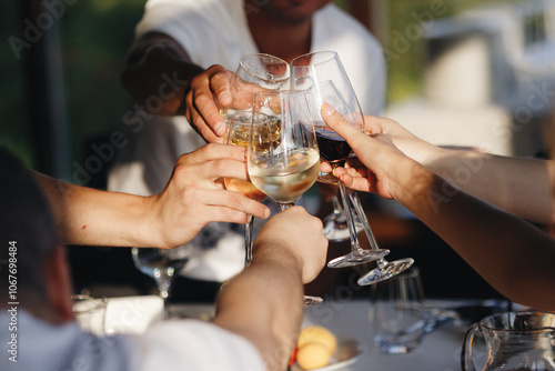 Wallpaper Mural Celebrating with glasses of alcohol in hands. Happy friends having good time. Torontodigital.ca