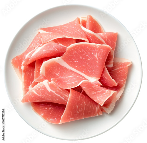 Close-up of thin slices of cured ham on a white plate.