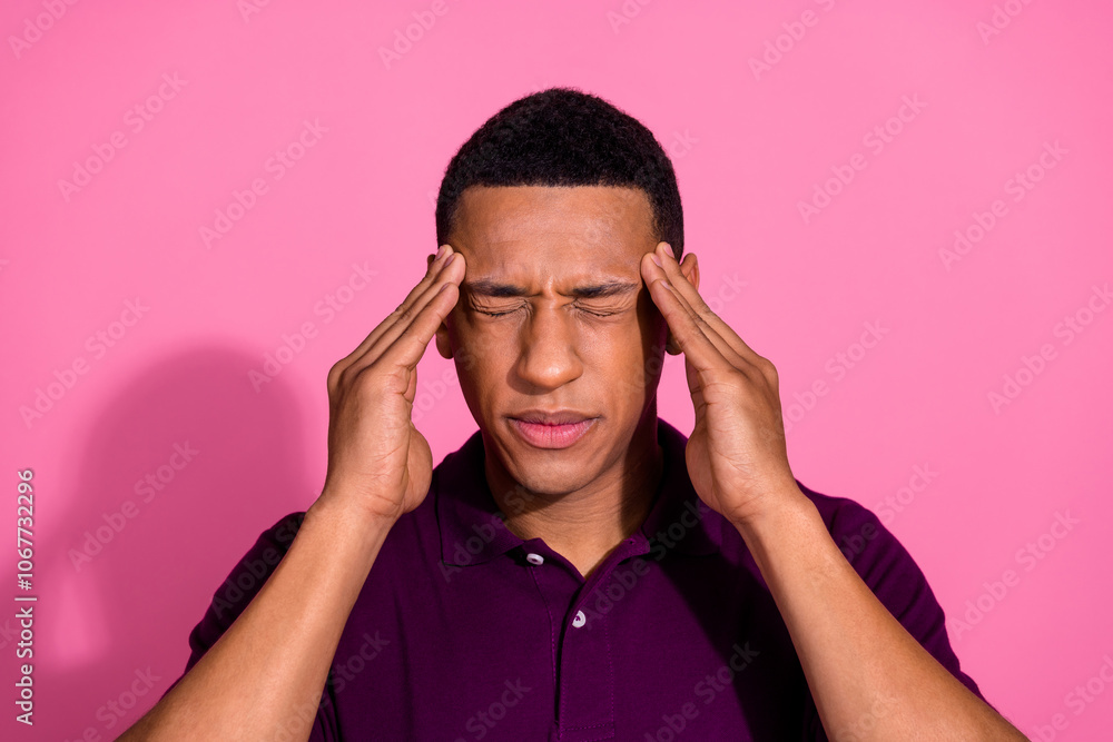 Photo portrait of attractive young man touch temples migraine dressed stylish violet clothes isolated on pink color background Photo portrait of attractive young man touch temples migraine dressed stylish violet clothes isolated on pink color background