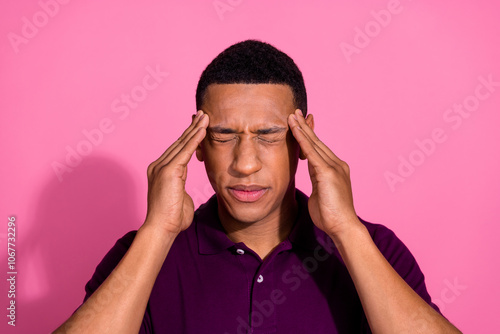 Photo portrait of attractive young man touch temples migraine dressed stylish violet clothes isolated on pink color background