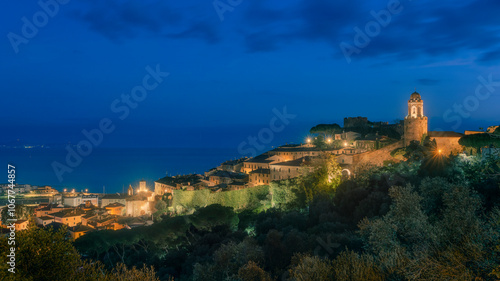 Blue hour over Castiglione della Pescaia, old town and sea. Maremma Tuscany, Italy