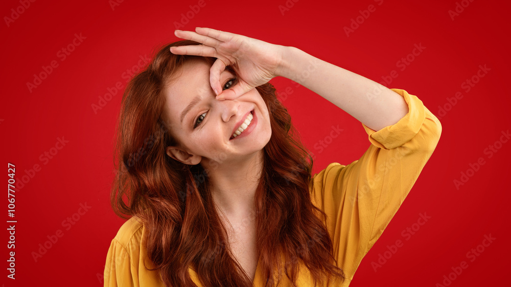 Teen Girl Gesturing Okay Sign Holding Hand Near Eye Having Fun Posing Over Green Background. Studio Shot, Panorama Teen Girl Gesturing Okay Sign Holding Hand Near Eye Having Fun Posing Over Green Background. Studio Shot, Panorama