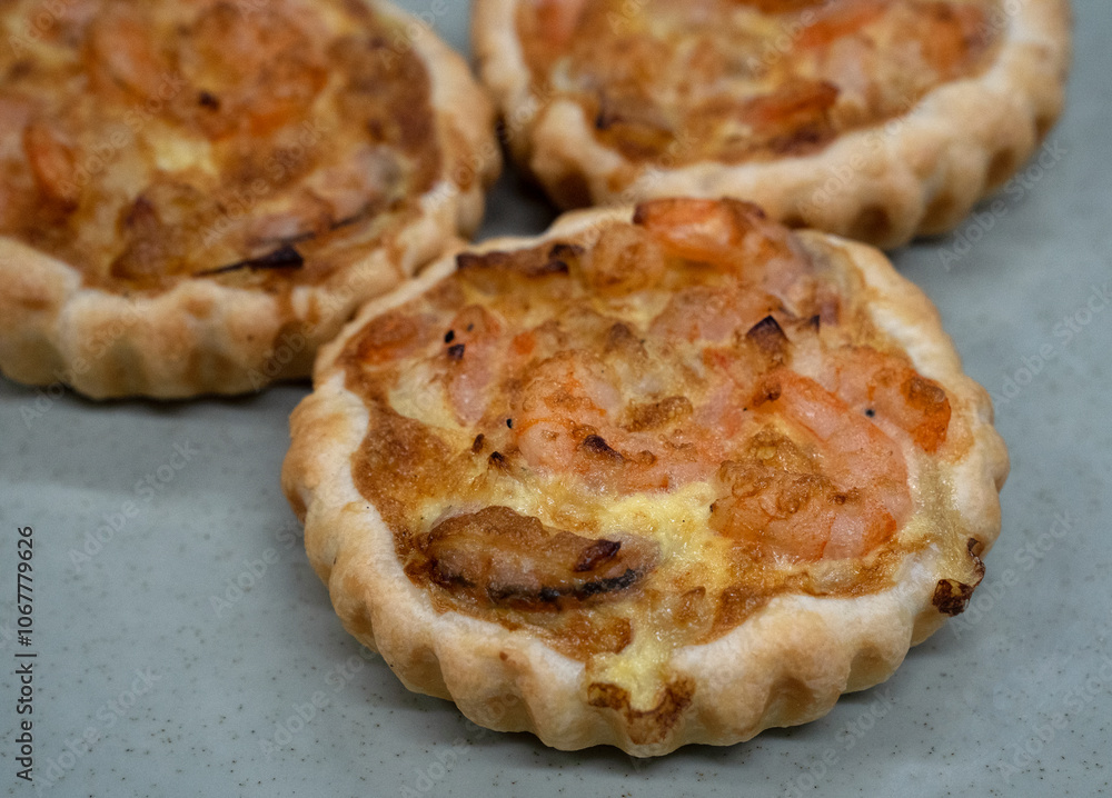 Seafood and bakery. Closeup view of a shrimp pie with gratin cheese Seafood and bakery. Closeup view of a shrimp pie with gratin cheese