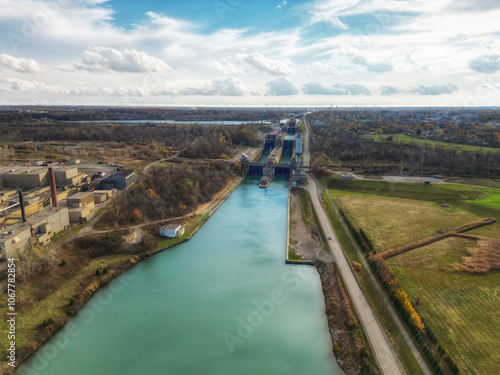 Aerial over the Welland Canal, part of the St. Lawrence Seaway and Great Lakes Waterway in St. Catharines, Ontario, Canada. Looking south towards lock 5 in Thorold. Autumn in November 2024.