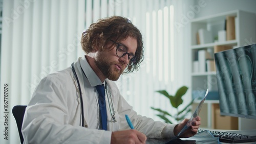 A Doctor Works, Analyzing X-rays and CT Scans on a Computer Screen He Reviews Digital Medical Data to Provide Accurate Diagnoses and Treatment Plans. Concept of Medical Professionalism and Expert Care