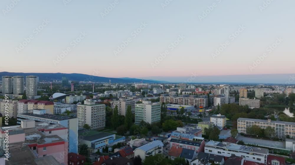 The camera pans over the city of Bratislava, Slovakia showing a residential area with apartment buildings and other structures The camera pans over the city of Bratislava, Slovakia showing a residential area with apartment buildings and other structures
