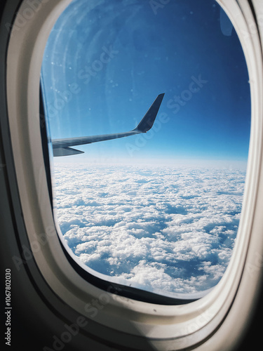 View from a plane of the wing over the clouds