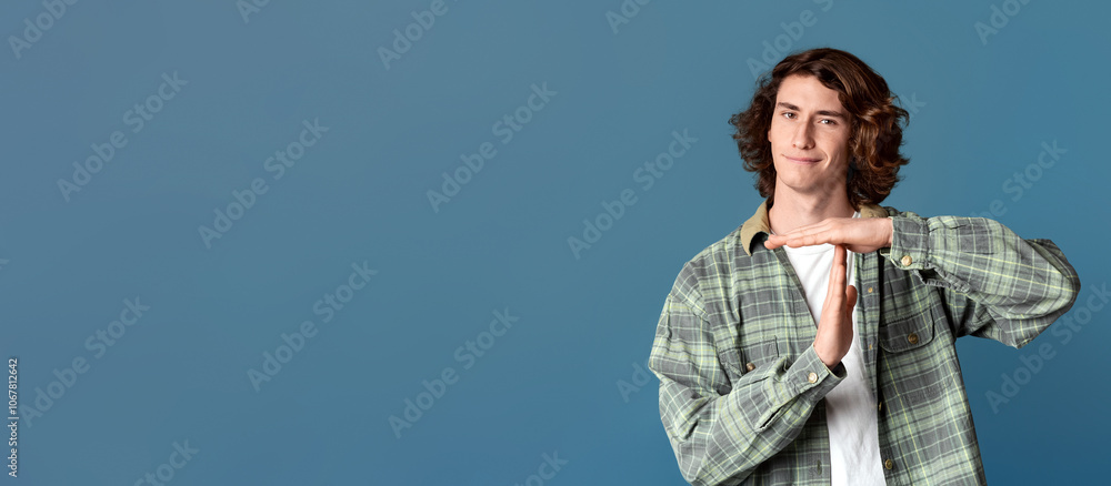 Expressing refusal. Serious teenager gesturing TIME OUT on turquoise background