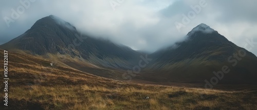 Explore the breathtaking beauty of dramatic mountain peaks shrouded in low clouds photo