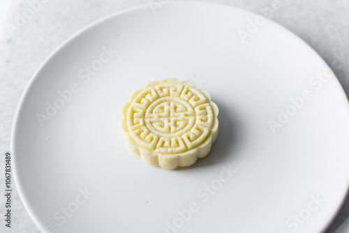 Overhead view of tuwon madara on a white plate, nigerian alawar madara milk candy, top view of milk fudge on a white ceramic plate photo