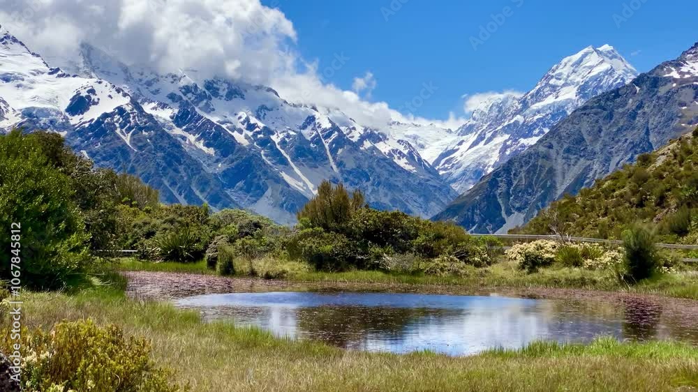Hill top view of Aoraki Mount Cook and blue sky with clouds reflecting in water at Red Tarns, Mount Cook National Park, New Zealand. Reflection in the lake. Landscape with lake and mountains Hill top view of Aoraki Mount Cook and blue sky with clouds reflecting in water at Red Tarns, Mount Cook National Park, New Zealand. Reflection in the lake. Landscape with lake and mountains