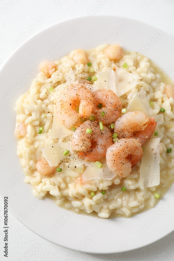 Delicious risotto with shrimps and cheese on white table, top view Delicious risotto with shrimps and cheese on white table, top view