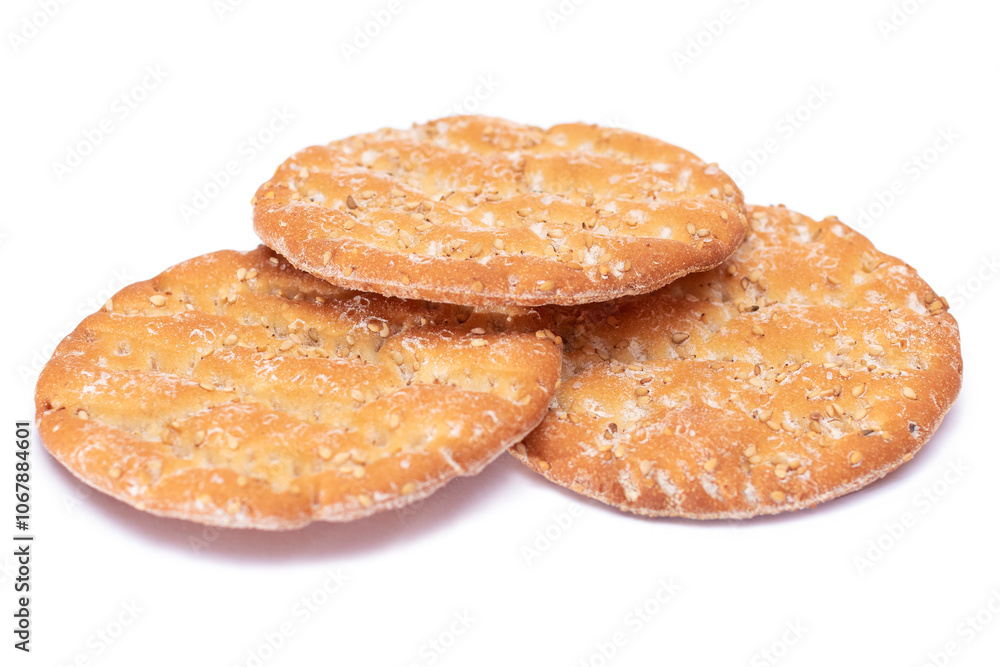 A Heap of Round Salt Crackers with Sesame Isolated on White Background. Dry Snacks - Isolation A Heap of Round Salt Crackers with Sesame Isolated on White Background. Dry Snacks - Isolation