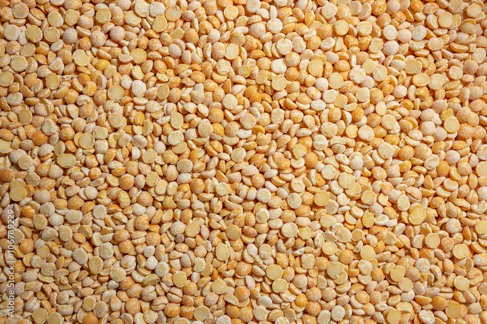 Uncooked Polished Split Peas Background. A Culinary Canvas of Dry Yellow Peas, Creating a Lively and Textured Background for Gourmet Cooking. Scattered Raw Polished Peas. Healthy Eating Ingredients Uncooked Polished Split Peas Background. A Culinary Canvas of Dry Yellow Peas, Creating a Lively and Textured Background for Gourmet Cooking. Scattered Raw Polished Peas. Healthy Eating Ingredients