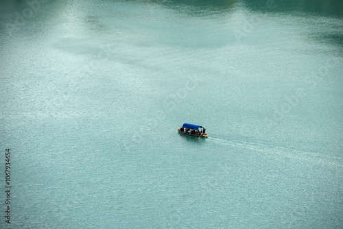 boat in the water lake bled slovenia (european travel tourism destination) castle island rent hire attraction beautiful julian alps clean water