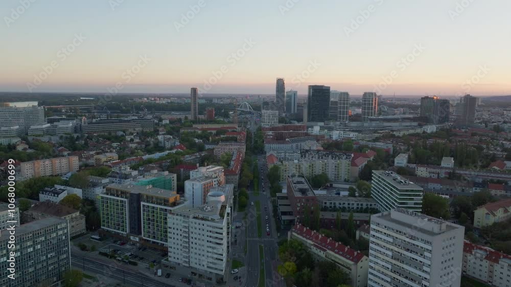 Bratislava, Slovakia's capital, slowly awakens as the sun rises above the horizon, bathing the cityscape in a warm, golden light Bratislava, Slovakia's capital, slowly awakens as the sun rises above the horizon, bathing the cityscape in a warm, golden light