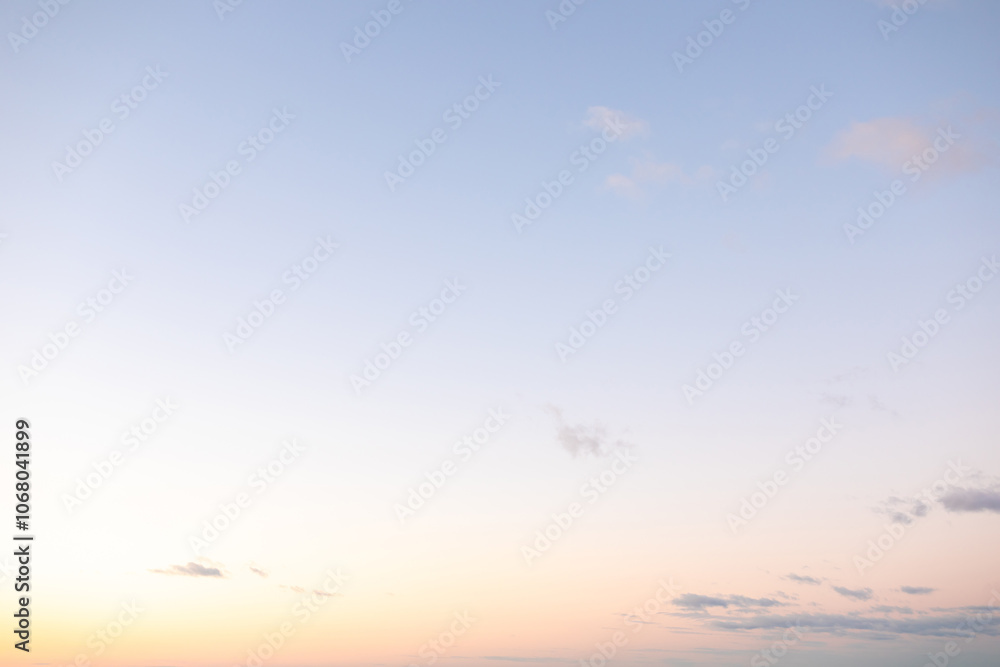 A calm twilight sky features gentle pastel shades blending into one another, creating a peaceful ambiance above the horizon. The scene evokes a sense of tranquility and beauty.
