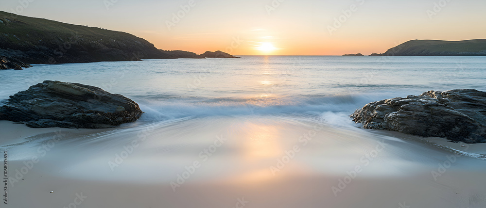 Tranquil beach at sunset with two rocks in foreground. Tranquil beach at sunset with two rocks in foreground.
