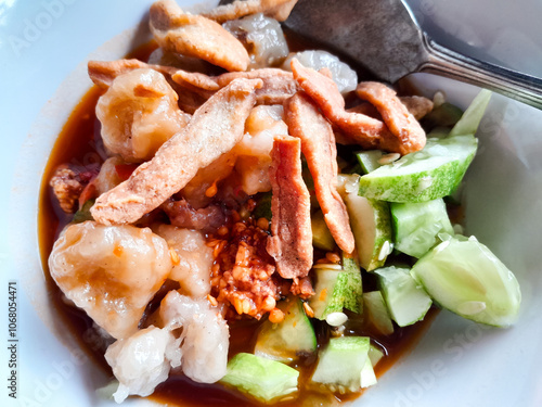 Siomay with delicious peanut sauce and cucumber topping photo