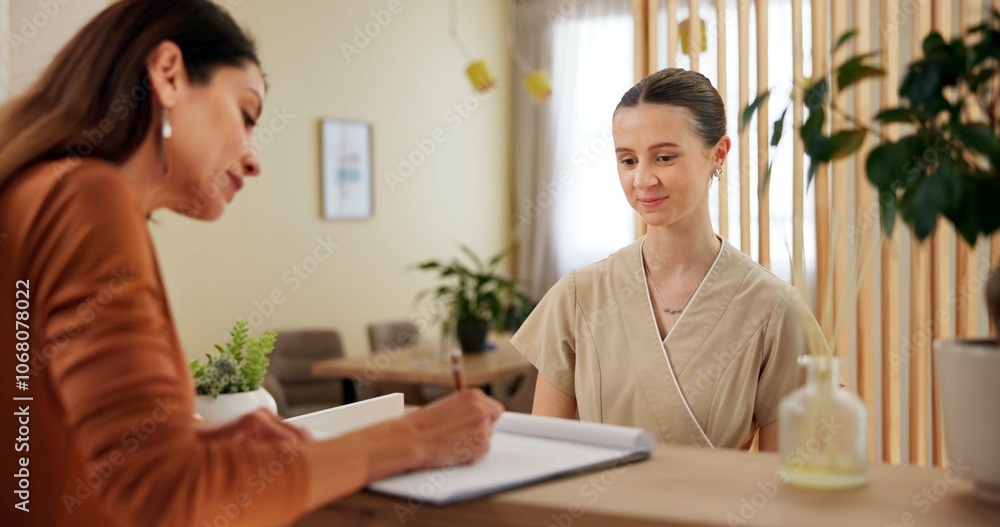 Women, customer and receptionist with signature at spa for luxury service, booking and reservation. People, employee and guest with smile at front desk for registration, filling form and agreement Women, customer and receptionist with signature at spa for luxury service, booking and reservation. People, employee and guest with smile at front desk for registration, filling form and agreement