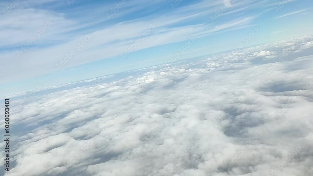 The view from the airplane window. Clouds at a blue sky The view from the airplane window. Clouds at a blue sky
