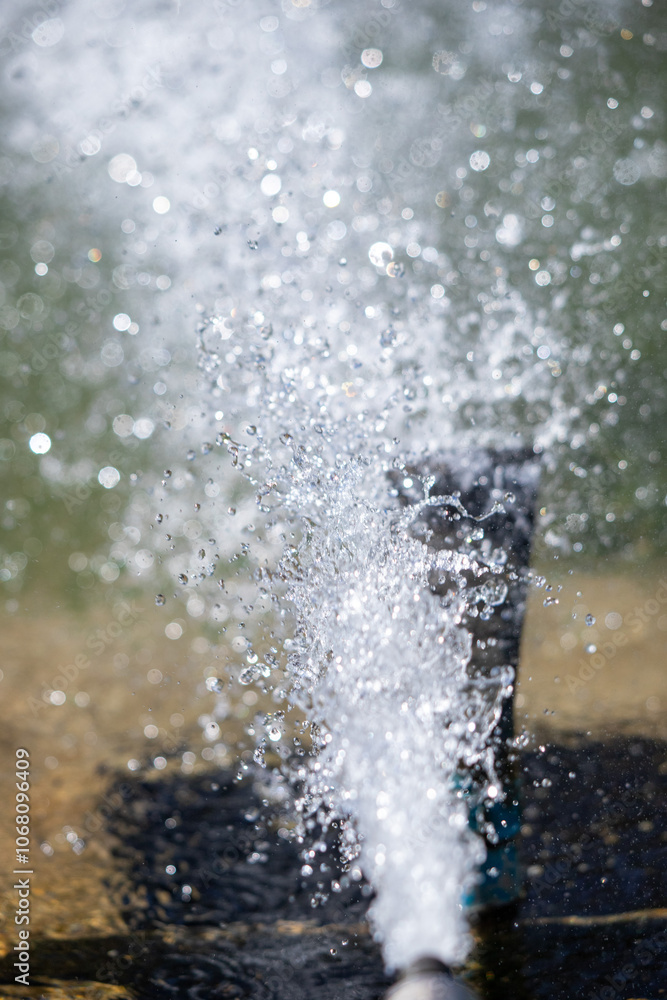 A water fountain is spraying water into the air A water fountain is spraying water into the air
