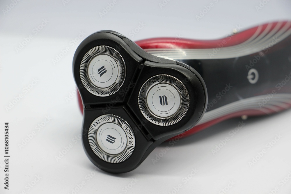 Electric razor with three blades on white background close-up Electric razor with three blades on white background close-up