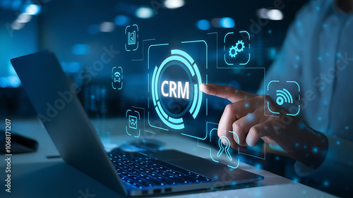 Wallpaper Mural person’s hand interacting with a CRM interface on a laptop with glowing icons for analytics, communication, contacts, and customer data Torontodigital.ca