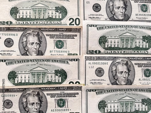 Close-up of paper American dollar bills. Dollar bills of 20 dollars lie face down and back down in a row on the table. Money financial background. Flat lay, close-up, top view photo