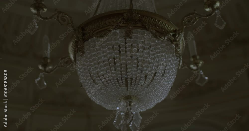 Beautiful close-up and slow motion shot of an antique and luxurious chandelier hanging in the living room of a classic mansion in Lima, Peru Beautiful close-up and slow motion shot of an antique and luxurious chandelier hanging in the living room of a classic mansion in Lima, Peru