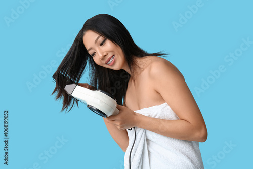 Young Asian woman drying ha...