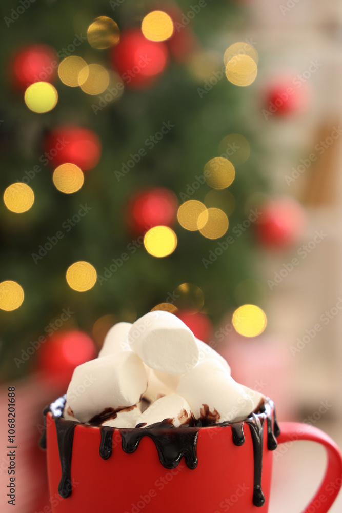 Cup of cocoa with marshmallows in room on Christmas eve, closeup Cup of cocoa with marshmallows in room on Christmas eve, closeup
