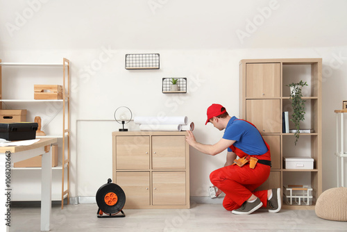 Male electrician repairing ...