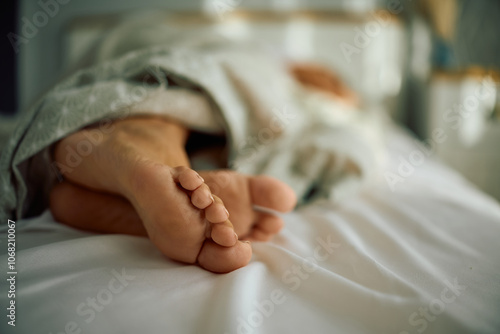 Close up of barefoot woman sleeping in bedroom. photo