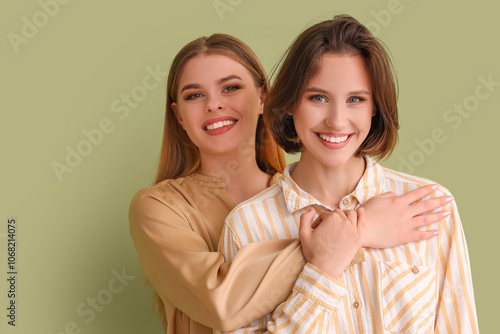 Female friends hugging on g...