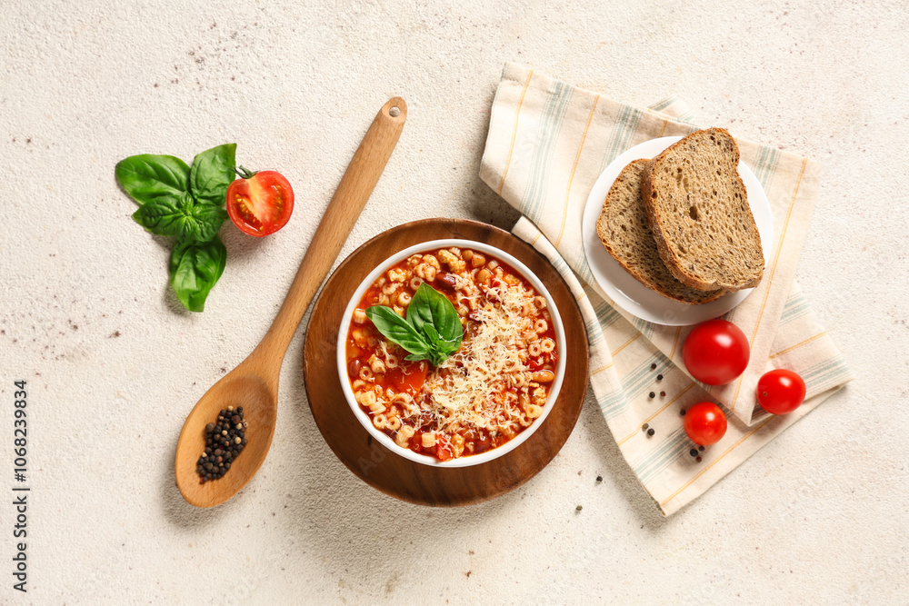 Bowl of pasta fagioli with ingredients and slices of bread on white background Bowl of pasta fagioli with ingredients and slices of bread on white background
