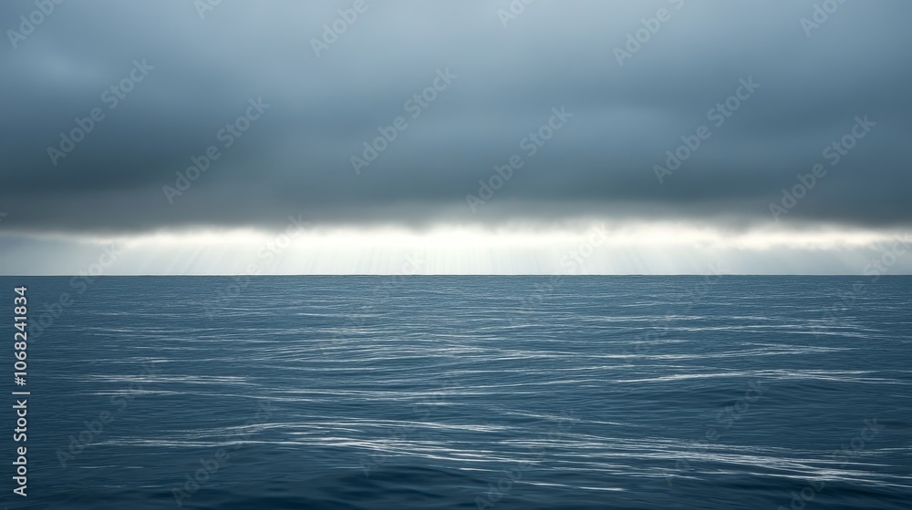 A serene ocean view under a cloudy sky with rays of light breaking through. A serene ocean view under a cloudy sky with rays of light breaking through.