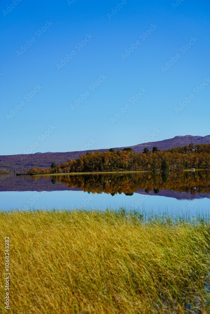 Scenic view of clear waters of a Norwegian mountain lake reflect the sky Scenic view of clear waters of a Norwegian mountain lake reflect the sky