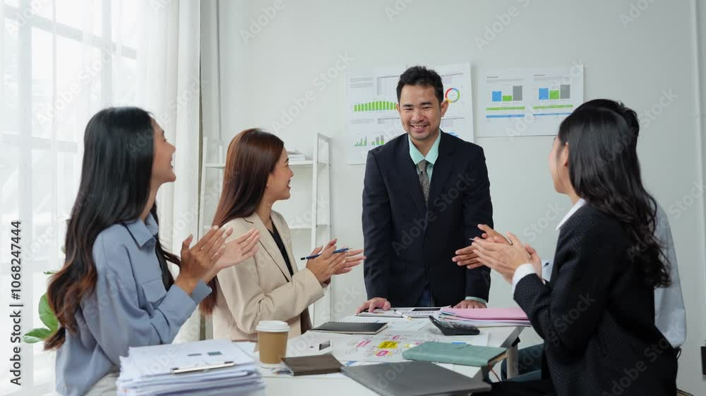 A team of office workers works, meets, discusses and is celebrating a financial business success. Show signs of joy, clapping, and cheerfulness in working together. Success concept. A team of office workers works, meets, discusses and is celebrating a financial business success. Show signs of joy, clapping, and cheerfulness in working together. Success concept.
