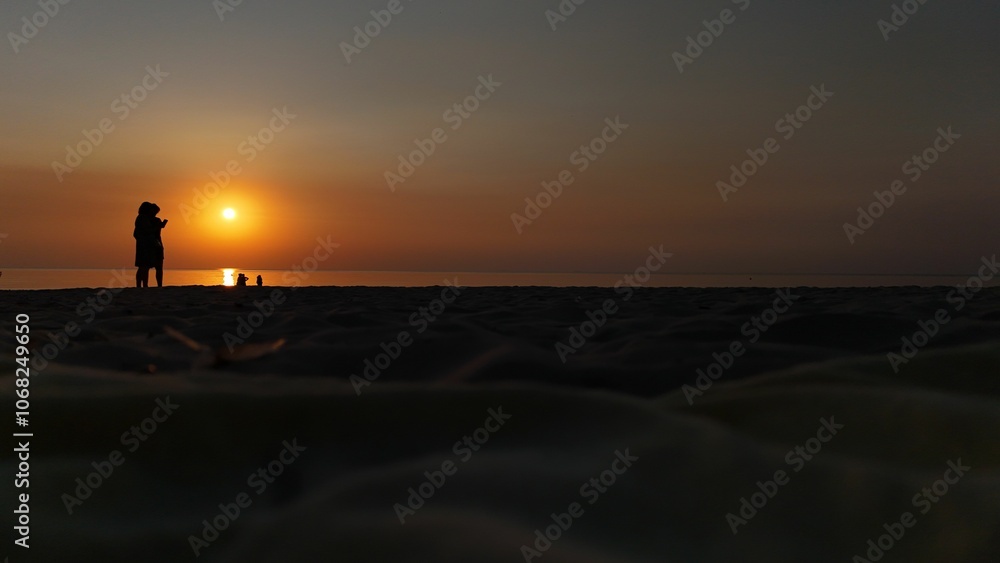 Beach sunset silhouette with orange sky. Beach sunset silhouette with orange sky.