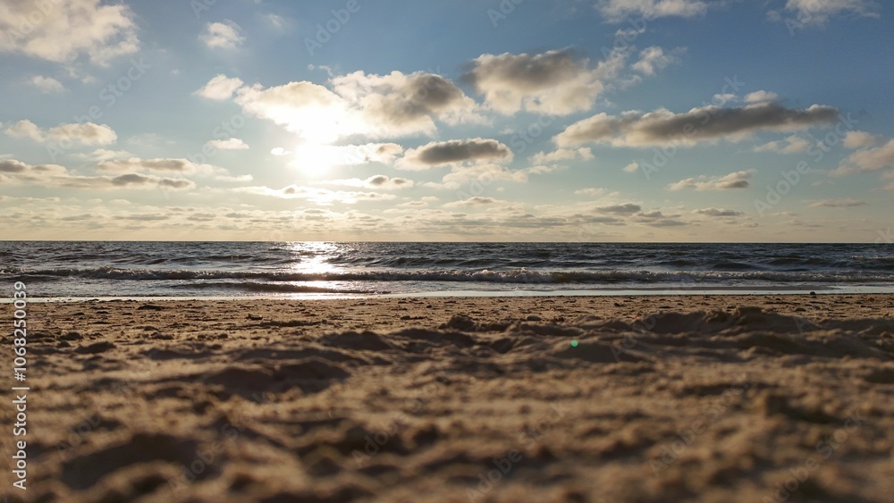 Sunset over a sandy beach with waves. Sunset over a sandy beach with waves.