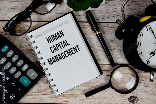 Human Capital Management (HCM) text on notepad, Business and Financial concept background