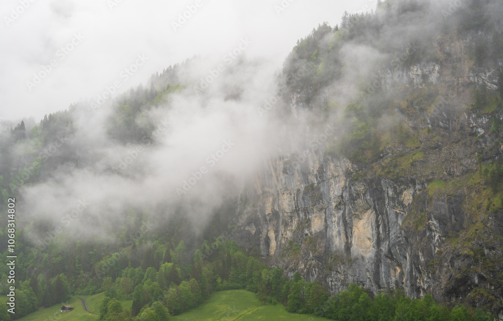 Fototapeta premium Lauterbrunnen, Village in Switzerland, in the Swiss Alps, Beautiful Valley with rocky cliffs and Waterfalls, Known as the Land of 72 Waterfalls