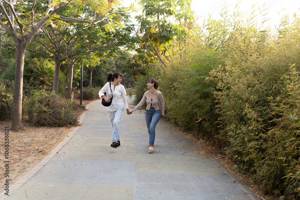 Two girls in a loving couple sharing a tender moment at the park Two girls in a loving couple sharing a tender moment at the park