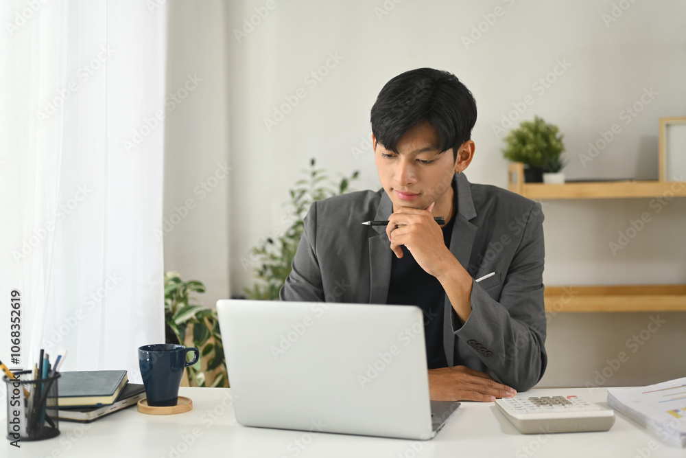 Professional businessman concentrating on work in a modern office Professional businessman concentrating on work in a modern office