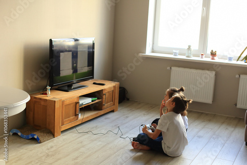 A lively scene of a boy and girl enthusiastically playing video games together at home. they immerse themselves in the gaming experience, highlighting the joy of childhood and the importance of friend